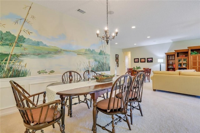 dining room featuring a chandelier and light carpet