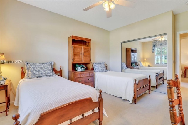 carpeted bedroom with a closet and ceiling fan