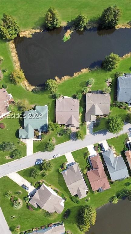 birds eye view of property with a water view