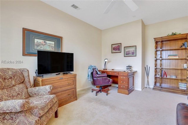 carpeted home office with ceiling fan