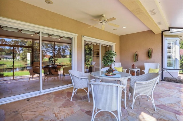 sunroom / solarium with plenty of natural light and ceiling fan