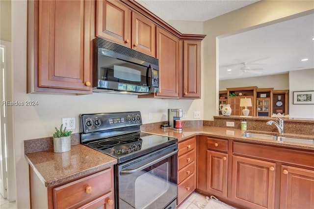 kitchen with ceiling fan, light stone countertops, sink, and black appliances