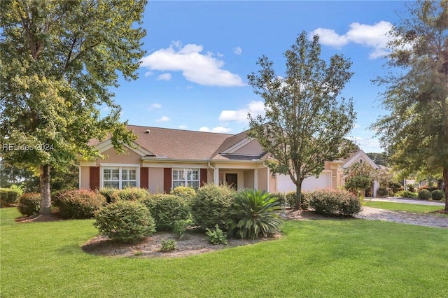 ranch-style house featuring a garage and a front yard