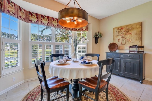 dining room with light tile patterned floors and a healthy amount of sunlight