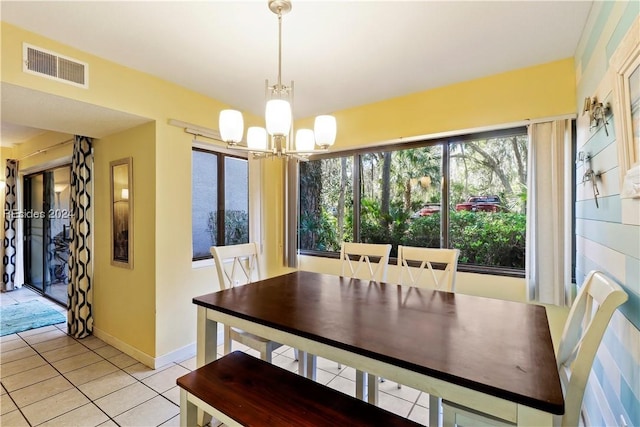 tiled dining room with a notable chandelier and plenty of natural light