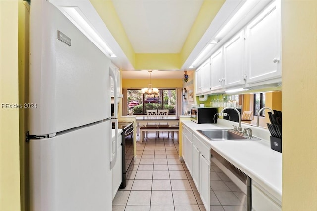 kitchen featuring sink, dishwashing machine, white cabinets, white fridge, and light tile patterned floors