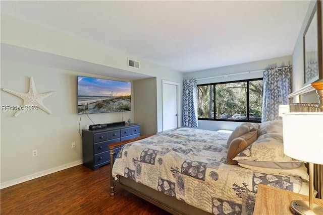 bedroom with dark hardwood / wood-style flooring