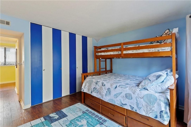 bedroom with dark hardwood / wood-style flooring