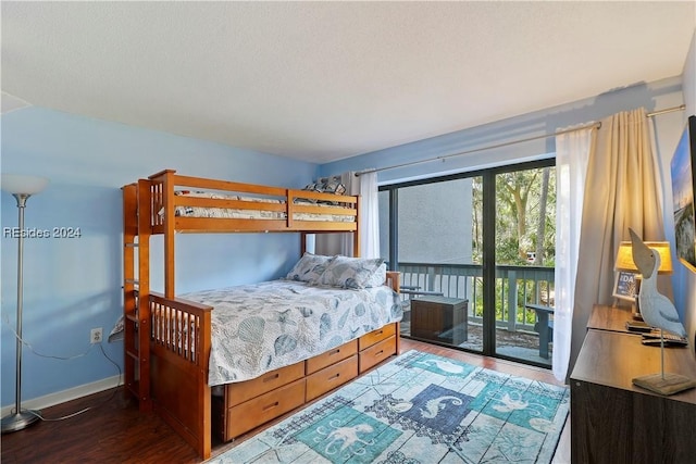 bedroom with dark hardwood / wood-style flooring and access to outside