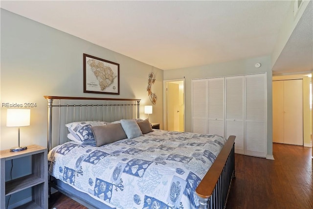 bedroom with dark hardwood / wood-style floors