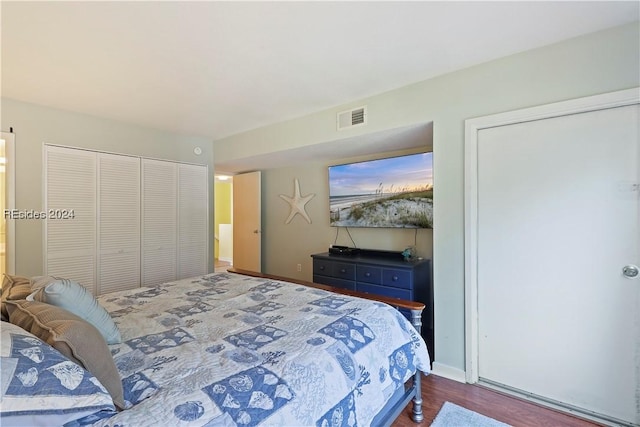 bedroom featuring hardwood / wood-style floors and a closet