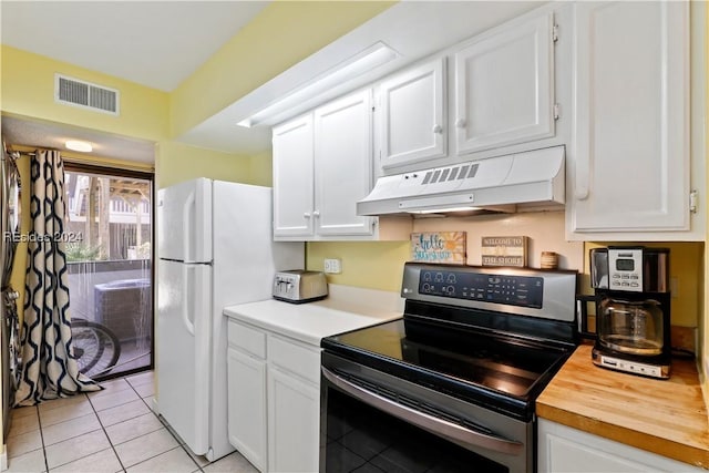 kitchen featuring white cabinets, premium range hood, and stainless steel electric stove