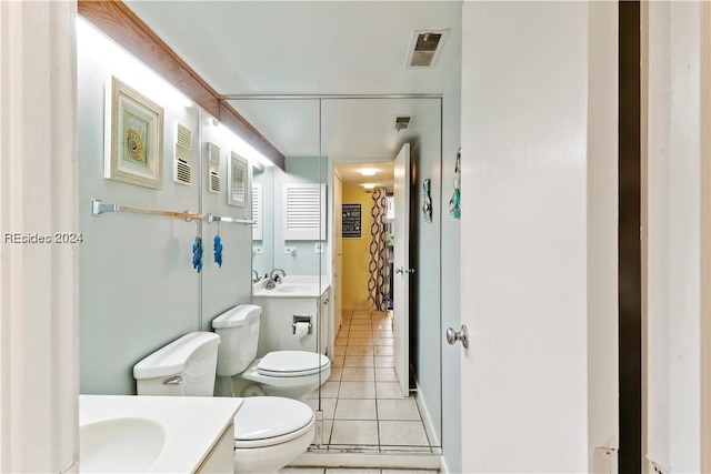 bathroom with vanity, toilet, and tile patterned flooring