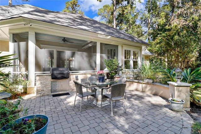 view of patio / terrace with ceiling fan, an outdoor kitchen, and grilling area