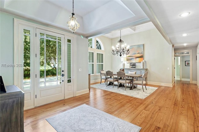 dining room with an inviting chandelier, light hardwood / wood-style floors, and a wealth of natural light