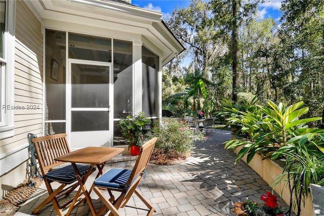 view of patio with a sunroom