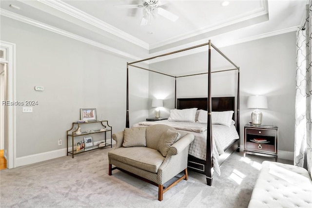 bedroom featuring a raised ceiling, crown molding, carpet flooring, and ceiling fan