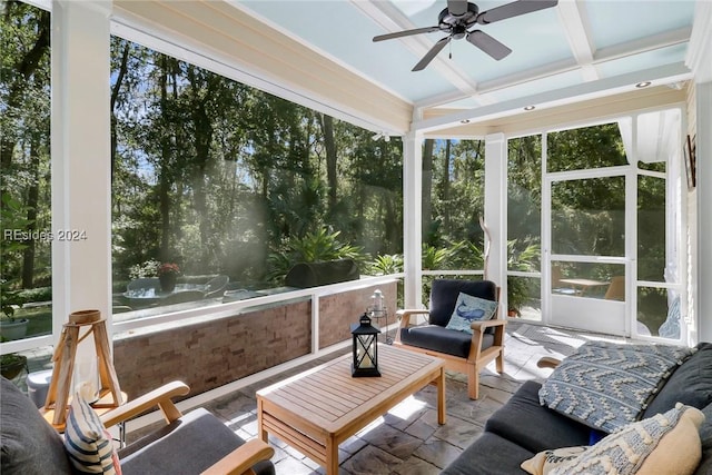 sunroom with beamed ceiling, ceiling fan, a healthy amount of sunlight, and coffered ceiling