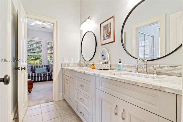 bathroom with tile patterned flooring, vanity, and crown molding