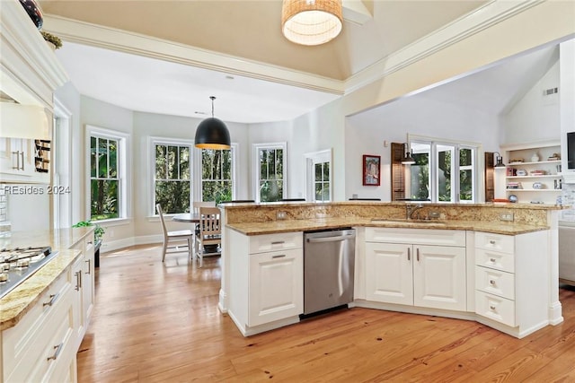 kitchen with pendant lighting, sink, white cabinets, light hardwood / wood-style floors, and stainless steel appliances