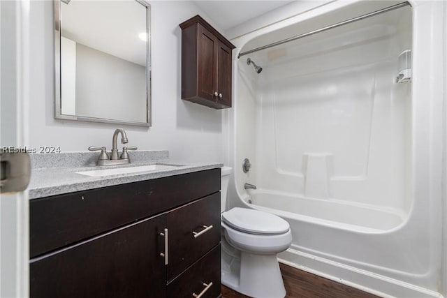 full bathroom featuring vanity, toilet, hardwood / wood-style floors, and  shower combination