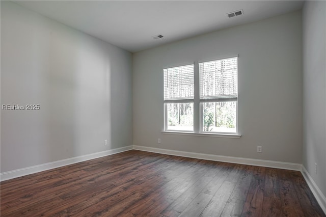 unfurnished room featuring a healthy amount of sunlight and dark hardwood / wood-style flooring