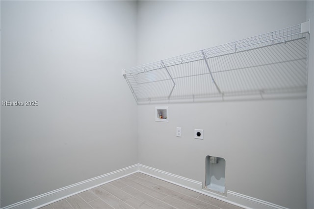 laundry area with electric dryer hookup, washer hookup, and hardwood / wood-style flooring