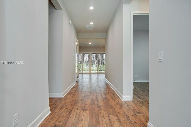 hallway with wood-type flooring