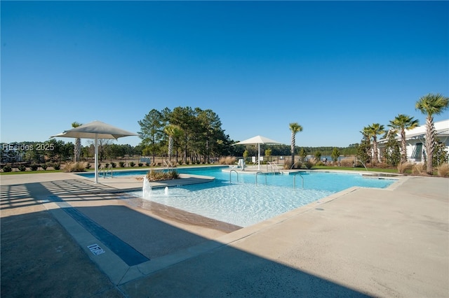 view of swimming pool featuring pool water feature and a patio area