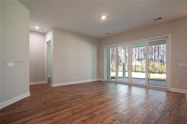 spare room featuring dark wood-type flooring