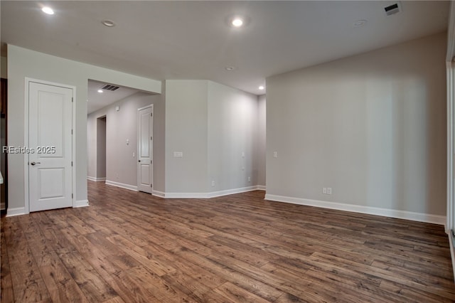 unfurnished room with dark hardwood / wood-style flooring