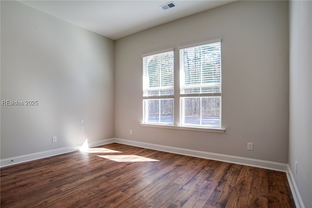 spare room featuring dark hardwood / wood-style flooring