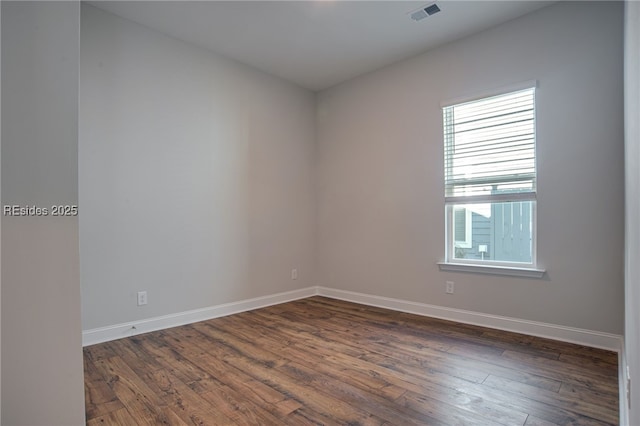 empty room with dark wood-type flooring