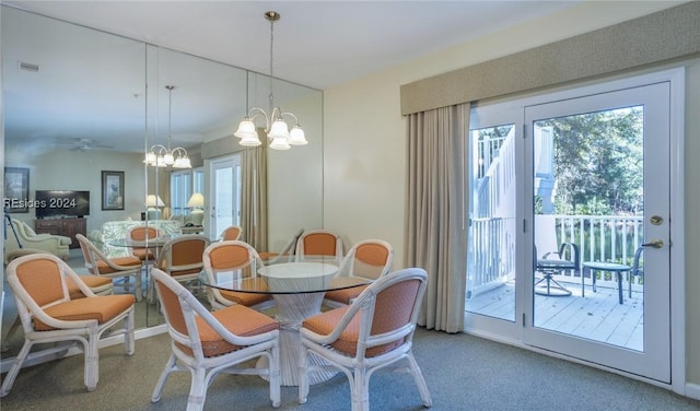 carpeted dining area featuring an inviting chandelier