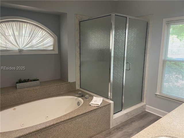 bathroom featuring wood-type flooring and independent shower and bath