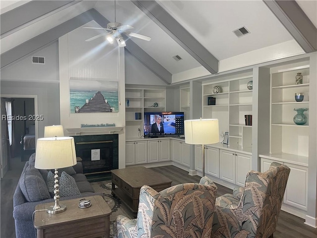 living room featuring dark hardwood / wood-style floors, vaulted ceiling with beams, built in features, and ceiling fan