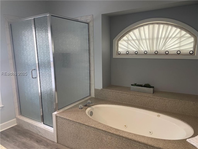 bathroom with plus walk in shower and hardwood / wood-style floors