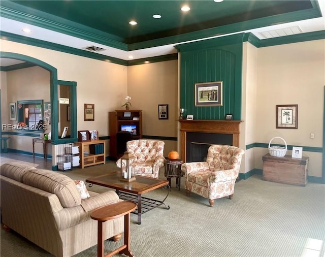 interior space with crown molding, carpet flooring, and a raised ceiling