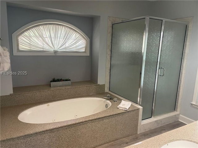 bathroom featuring vanity and plus walk in shower