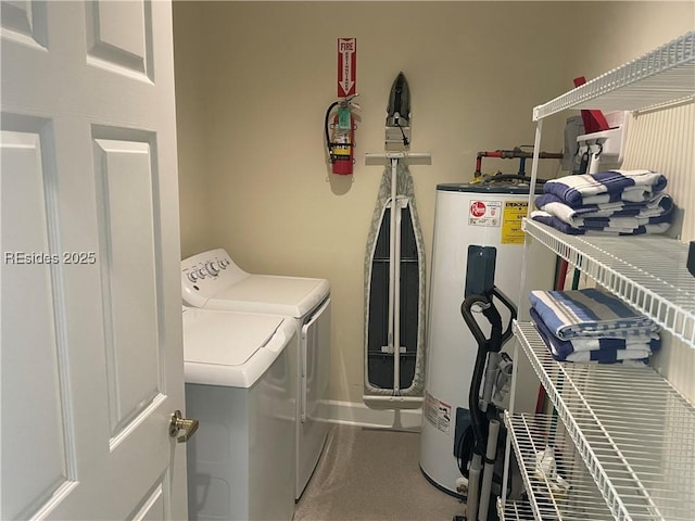 laundry area with washing machine and clothes dryer and water heater