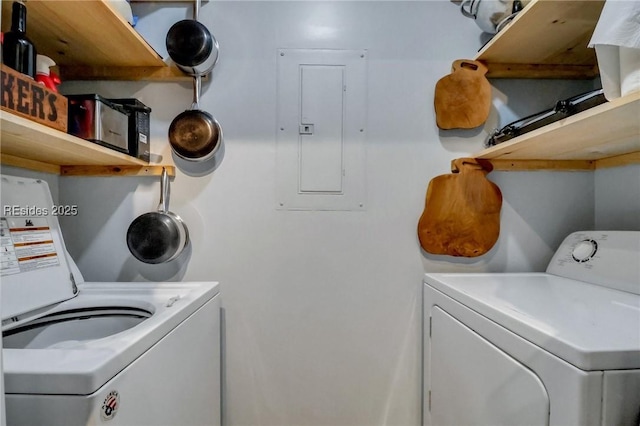 laundry area featuring washing machine and clothes dryer and electric panel