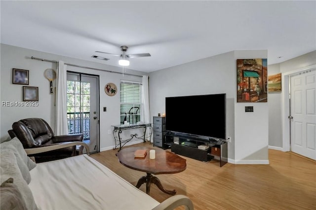 living room with hardwood / wood-style flooring and ceiling fan