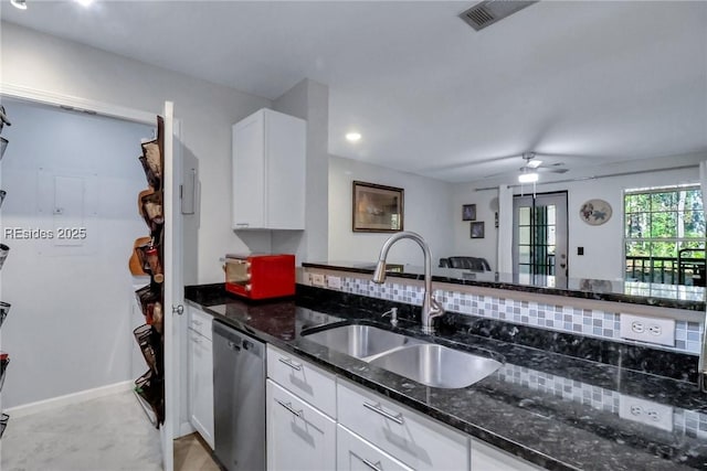 kitchen featuring sink, white cabinetry, stainless steel dishwasher, ceiling fan, and dark stone counters