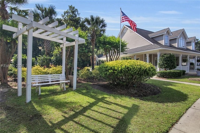 view of property exterior with a pergola and a lawn