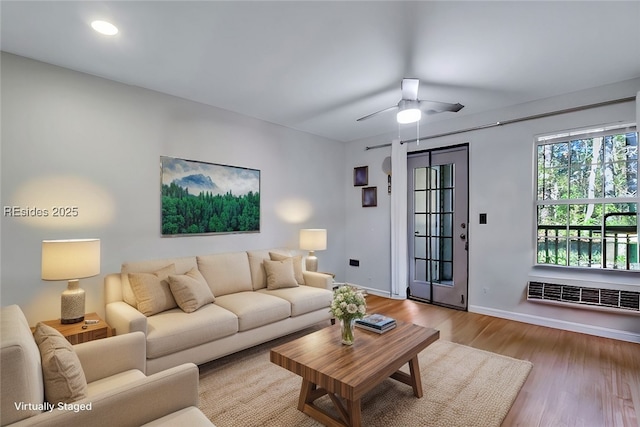 living room featuring light hardwood / wood-style floors and ceiling fan