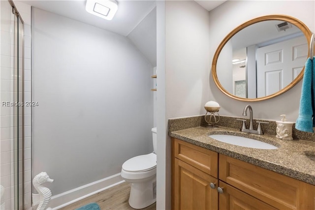 bathroom featuring wood-type flooring, vanity, and toilet