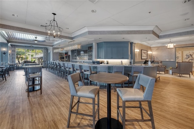 dining area with crown molding and light hardwood / wood-style flooring