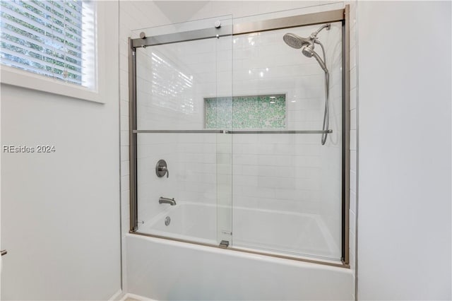 bathroom featuring shower / bath combination with glass door