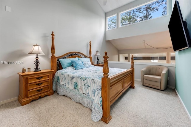 bedroom featuring lofted ceiling and light colored carpet