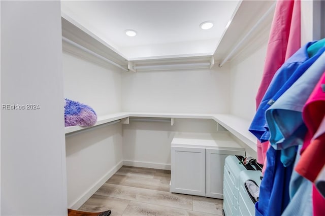 spacious closet featuring light hardwood / wood-style flooring